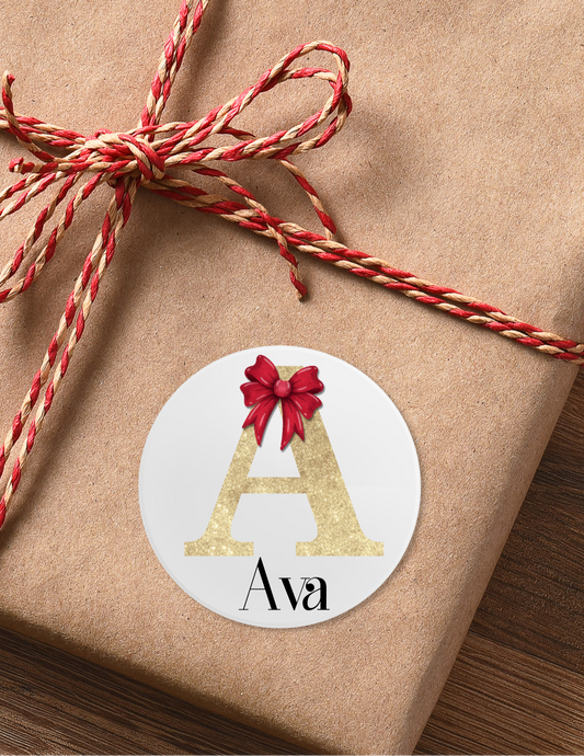 personalised christmas Stickers. Gold Glitter initial with a red 3D bow placed on it, then under your chosen name
